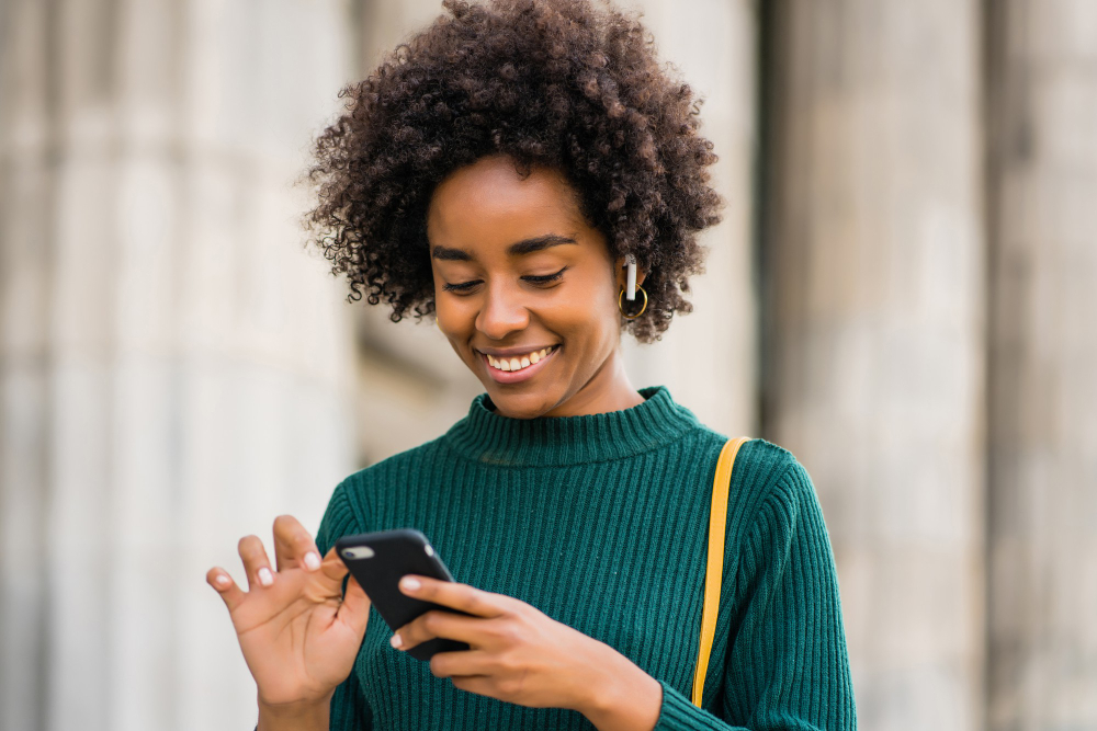 Reader browsing Tuzo Magazine on her phone